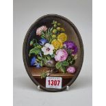 A Continental porcelain floral painted plaque, 14.5 x 11cm oval.