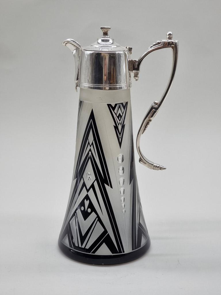 An Art Deco style electroplate mounted etched glass claret jug, 28.5cm high; together with a similar