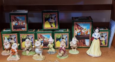 A set of Royal Doulton Snow White and The Seven Dwarfs figures, each boxed.
