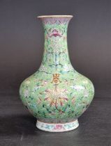 A Chinese lime-green ground famille rose vase, 17.5cm high.