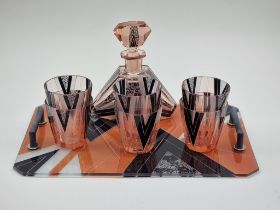 An Art Deco pink glass decanter set, the tray 42cm wide.
