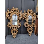 A pair of rococo style card giltwood frame wall mirrors, 114 x 67cm. (2)