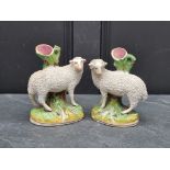 A pair of Victorian Staffordshire pottery sheep, 18cm high.