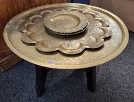 An Islamic brass tray, 64cm diameter, on associated hardwood stand; together with another Indian