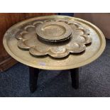 An Islamic brass tray, 64cm diameter, on associated hardwood stand; together with another Indian