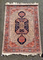 A Persian rug, having geometric cartouches to each corner, 210 x 140cm.