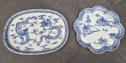 A Chinese blue and white dish, four character mark to base, painted with dragons, 34.5cm wide;