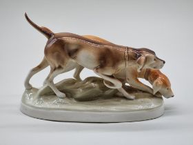 A Royal Dux figure group of two gun dogs, 30cm wide.