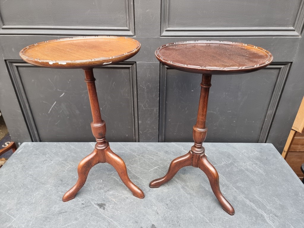 Two similar small mahogany reproduction tripod tables, largest 51.5cm high.