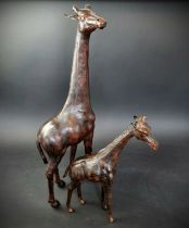 Two Liberty style tan leather giraffes, in the manner of Omersa, largest 74cm high.