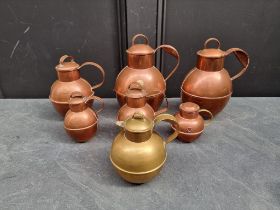 A graduated matched set of six copper Guernsey milk jugs and covers, largest 24cm high; together