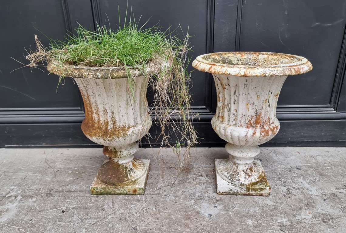 A pair of Victorian white painted cast iron urns, 48.5cm high. (2)