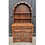 A small reproduction oak dresser and dome top rack, 91.5cm wide.