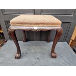 A 1930s, 18th century style, carved walnut and upholstered stool, 55cm wide.