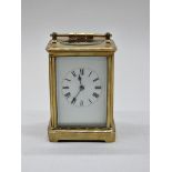 An old brass carriage timepiece, height including handle 17.5cm.