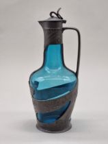 A Continental Art Nouveau pewter and blue glass claret jug, 29cm high.
