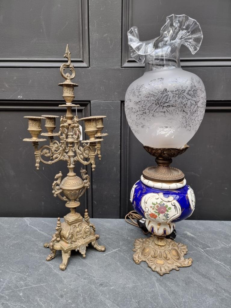 A brass four branched candelabrum; together with a pottery and brass table lamp. (2)
