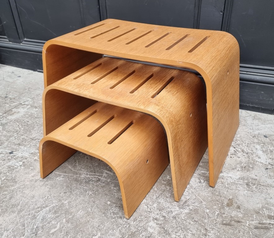 A nest of three contemporary bentwood occasional tables, largest 73cm wide.