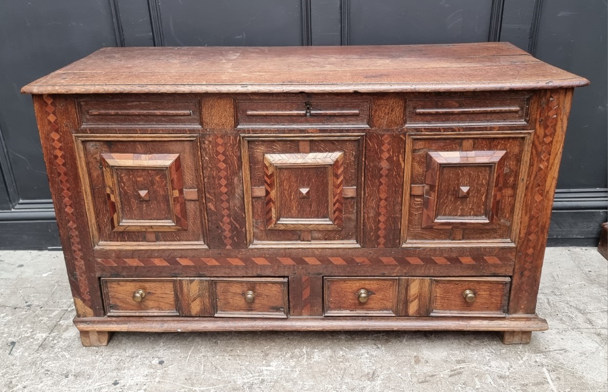 A late 17th century panelled oak and parquetry mule chest, 129.5cm wide.