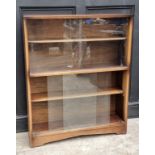 A mahogany bookcase, with glass sliding doors, 91.5cm wide, labelled Herbert E Gibbs.