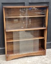 A mahogany bookcase, with glass sliding doors, 91.5cm wide, labelled Herbert E Gibbs.