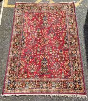 A Persian rug, central field decorated with floral urns and flowers, with floral borders, 277 x