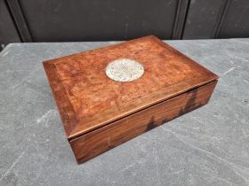 A Chinese hardwood box and cover, the sliding lid inset with a carved pale celadon jade roundel,