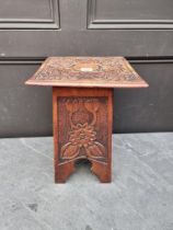 A small Arts and Crafts style carved pine occasional table, 28.5cm wide.