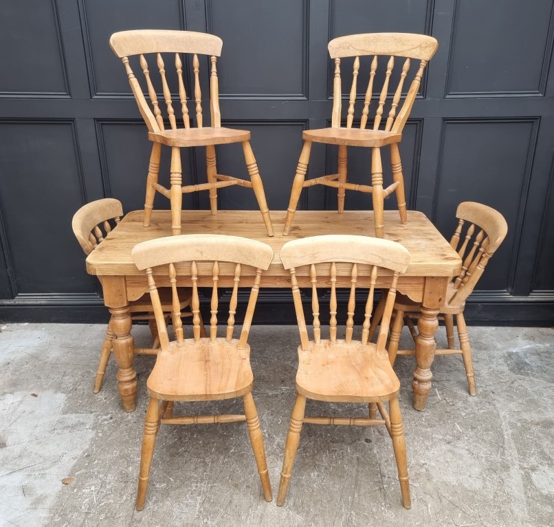 A pine kitchen table and six chairs, the table 152cm long.