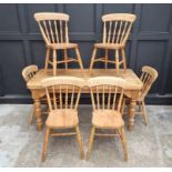 A pine kitchen table and six chairs, the table 152cm long.