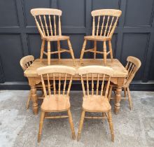 A pine kitchen table and six chairs, the table 152cm long.
