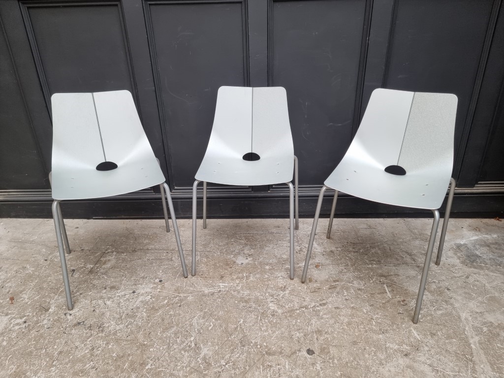 A set of three mid-century aluminium stacking chairs.