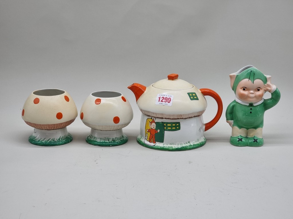 A Shelley 'Mabel Lucie Attwell' tea set, comprising: a teapot & cover; figural milk jug; and two