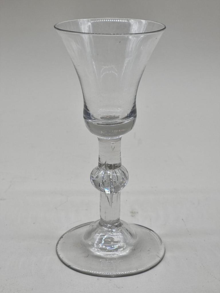 An 18th century beaded knop wine glass, 16.5cm high, (irregular foot rim).