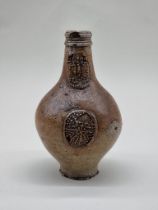 A salt glazed Bellarmine jug, probably 17th century, 23cm high, (a.f.).