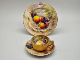 A Royal Worcester fruit painted cabinet cup and saucer, painted by Ricketts, the saucer 17cm