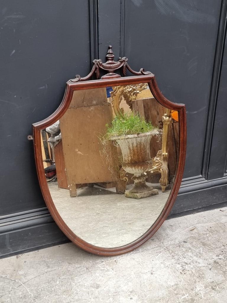A 1920s mahogany shield shaped wall mirror, 94 x 69cm.