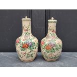 A pair of Japanese Satsuma pottery vases and covers, 26cm high. (2)