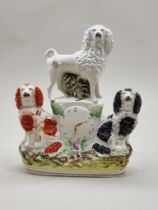 A Victorian Staffordshire pottery dog and clock figure group, 24.5cm high.