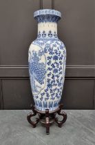 A large modern Chinese blue and white vase, 77cm high, on hardwood stand.