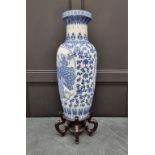 A large modern Chinese blue and white vase, 77cm high, on hardwood stand.