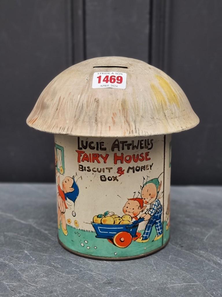 A scarce Lucie Attwell's 'Fairy House' Crawfords biscuit tin and money box, 20cm high.