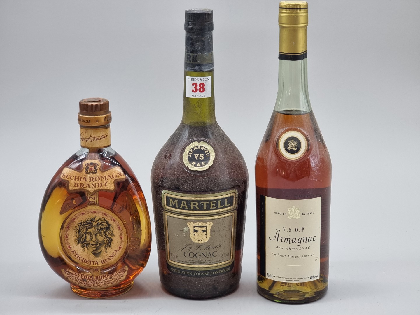 A 1 litre bottle of Martell VS Cognac; together with a 70cl bottle of VSOP Armagnac; and a 70cl