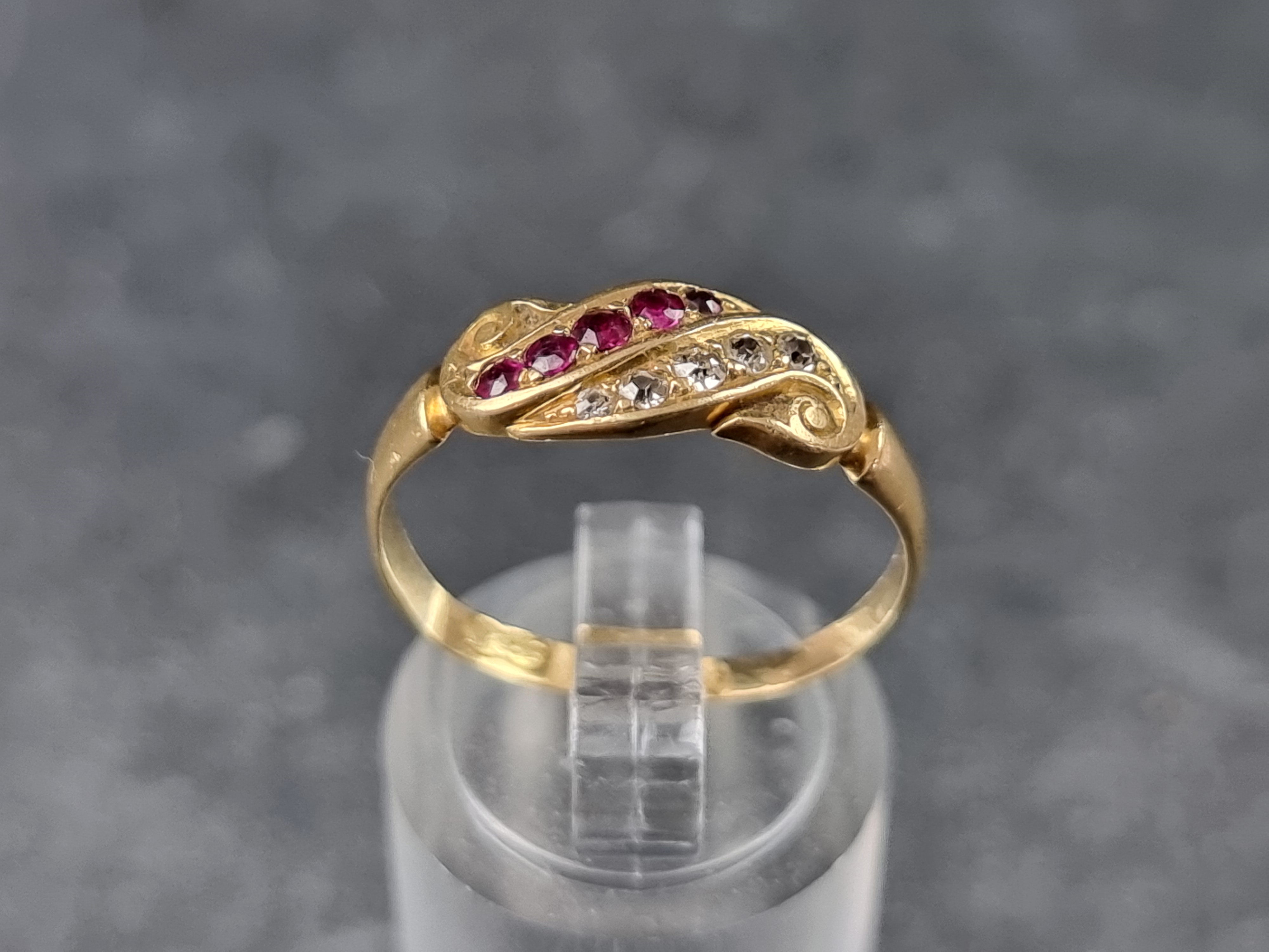 An 18ct gold ruby and diamond ring, set five diamonds and five rubies, size R, 2.6g.