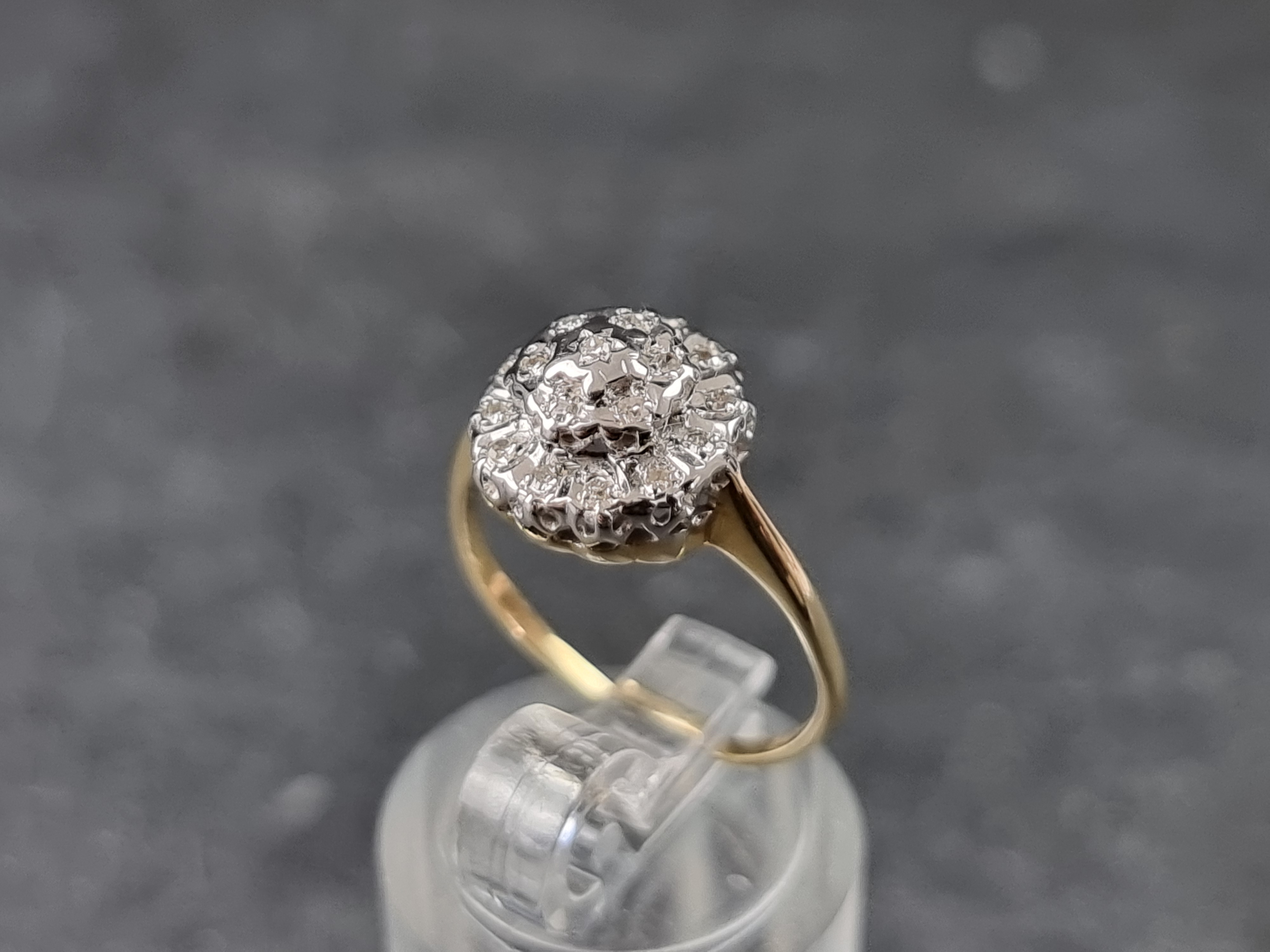 A 9ct gold diamond cluster ring, London 1985, size K 1/2, gross weight 2.1g.