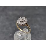 A 9ct gold diamond cluster ring, London 1985, size K 1/2, gross weight 2.1g.