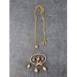 A late Victorian yellow metal and enamel pendant necklace, set three pink topaz and one pearl,