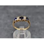An 18ct gold diamond and sapphire seven stone ring, Birmingham 2006, size L, gross weight 2.6g.