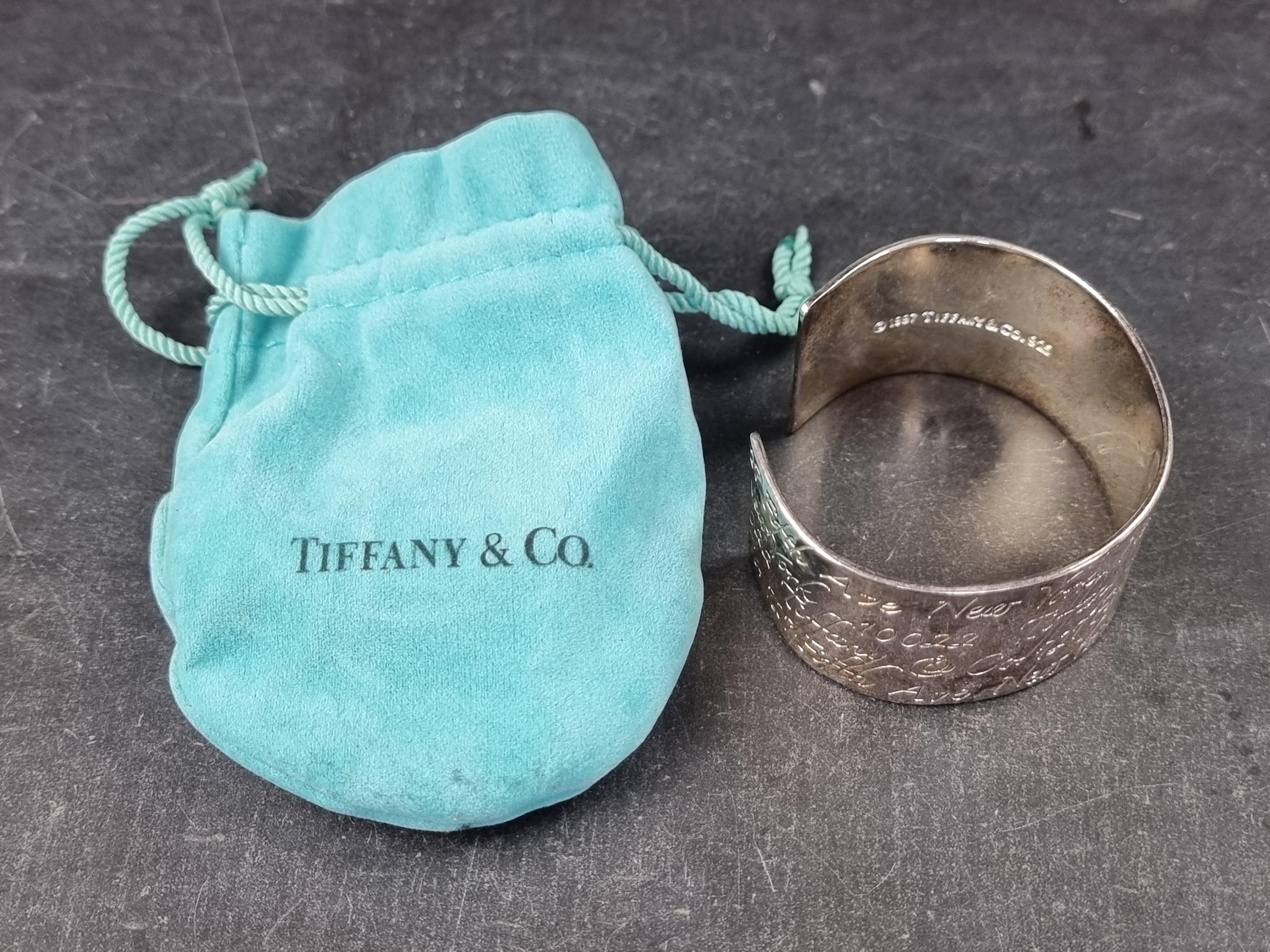 A Tiffany & Co script cuff bracelet, stamped 'Sterling', with drawstring pouch. - Image 4 of 4