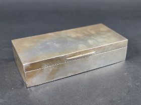 A silver cigarette box, maker's mark rubbed, London 1936, 11.5cm wide.